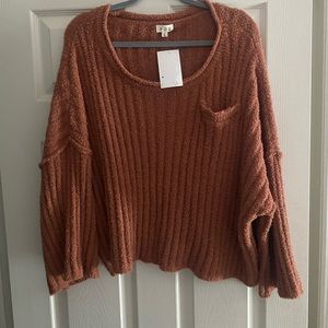This sweater was from a local boutique- never worn - still has tags size large